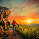 Mountainbiking man and woman, at sunset.