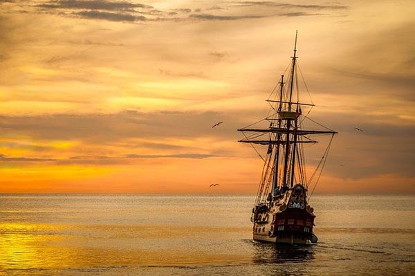 Sailing ship sailing into the sunset.