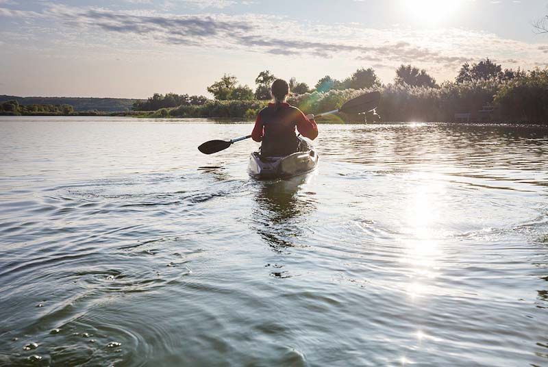 Kayaking on a river in summertime