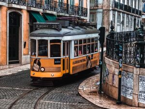 Yellow tram coming down a hill in Lisbon, Portugal