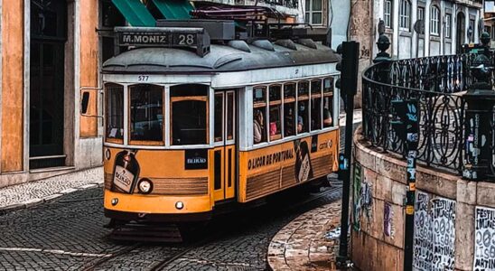 Yellow tram coming down a hill in Lisbon, Portugal