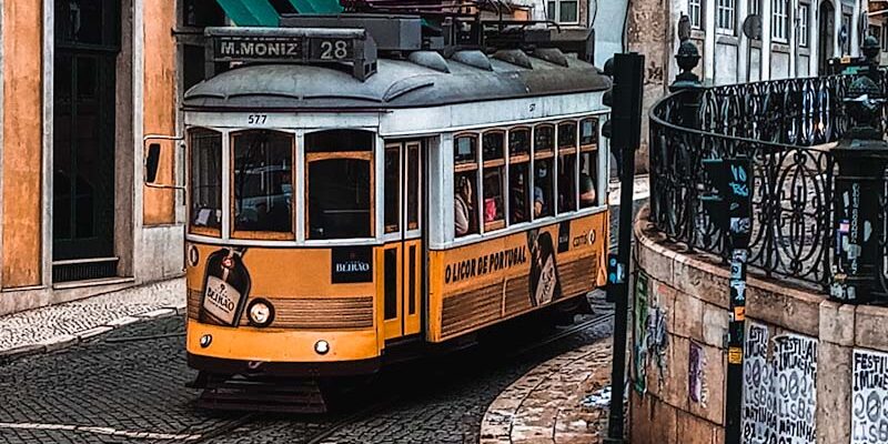 Yellow tram coming down a hill in Lisbon, Portugal