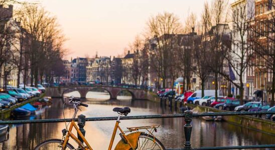 Bike leaning against a bridge in Amsterdam