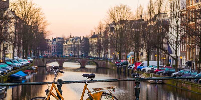 Bike leaning against a bridge in Amsterdam