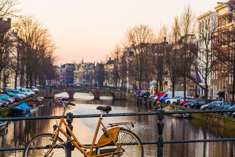 Bike leaning against a bridge in Amsterdam