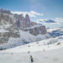 Skiers on a sunny day with mountains in the background