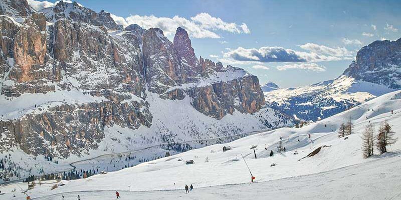 Skiers on a sunny day with mountains in the background