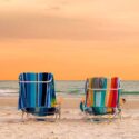 Orange sky and two beach chairs