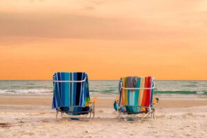 Orange sky and two beach chairs