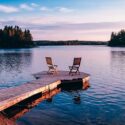 Wooden chairs on pier at sunset