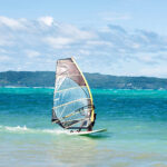 Windsurfer on a sunny day with blue hues everywhere