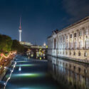 Party by the river Spree in Berlin at night. Television tower seen from afar.