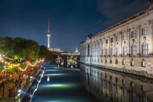 Party by the river Spree in Berlin at night. Television tower seen from afar.