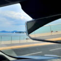 Rear view mirror showing beach in Cannes, France