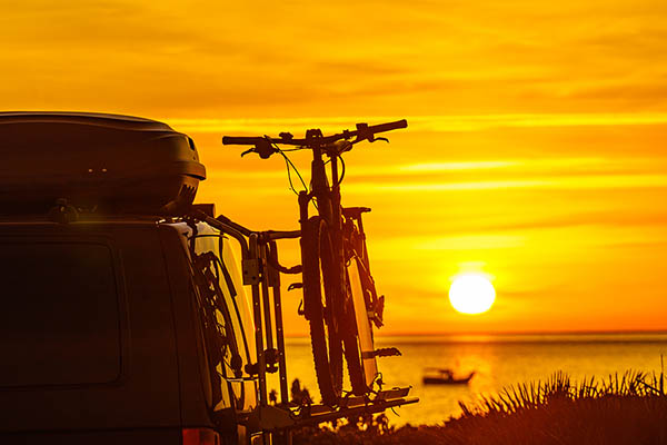 A motorhome with a bicycle strapped to the side.