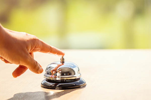 Ringing a hotel bell.