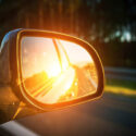 Sunset seen in a car's rearview mirror