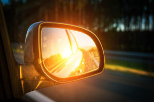 Sunset seen in a car's rearview mirror