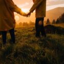 Couple holding hands at sunset in nature