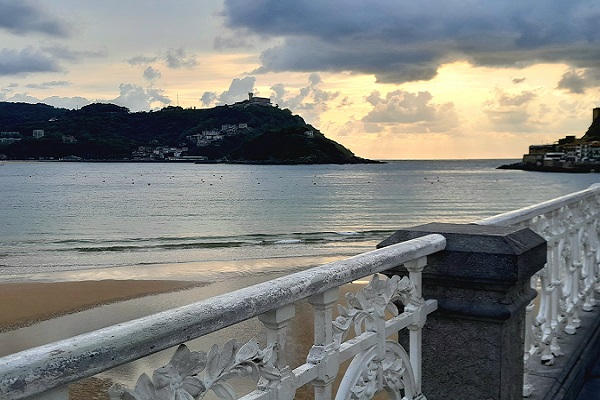 Beach view with dramatic clouds and sky in San Sebastian, Spain.