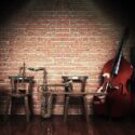 Lit stage with jazz instruments.