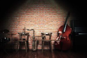 Lit stage with jazz instruments.
