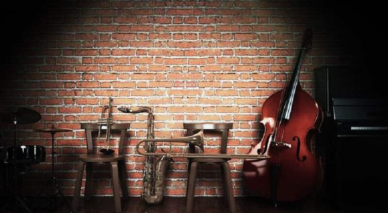 Lit stage with jazz instruments.